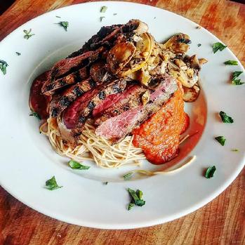 And Becomes: Whole wheat pasta with tomato cream basil topped with sauteed mushrooms and truffle rub grilled strip steak.